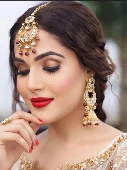 A close-up of this gorgeous party makeup. The soft brown smokey eye and bold red lip create a look that is both elegant and striking.