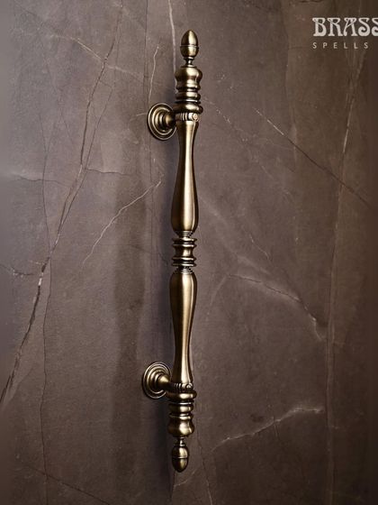 The Trident door pull, shown here in our Antique Brass finish, features a balanced, neo-classic design. Its turned detailing and substantial feel make it a perfect choice for adding a regal touch to any grand entrance.