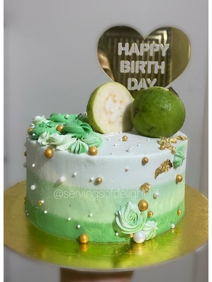 A truly unique request: a guava-themed cake! This red velvet cake is decorated with an ombre green buttercream and fresh guavas on top.