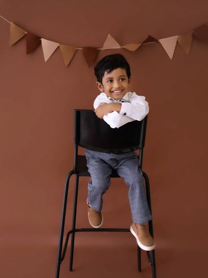 A charming smile from the birthday boy. These simple, classic portraits are a wonderful way to remember their personality at this age.
