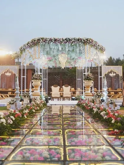 Your walk down the aisle should be nothing short of magical. We designed this breathtaking mandap with a glass floor over a bed of flowers, creating a pathway that feels like walking on a dream.