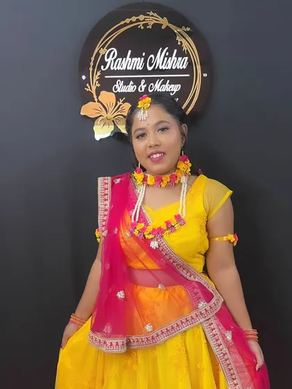 A full-length shot of the model in her yellow and pink Haldi lehenga, looking absolutely radiant.