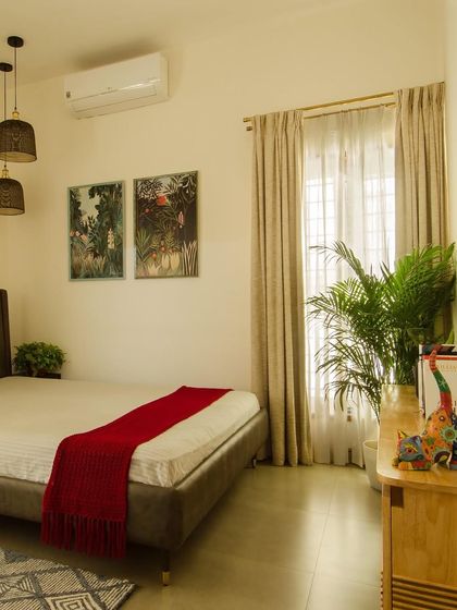 A serene bedroom space where simplicity reigns. The combination of off-white walls, warm wood accents, and plenty of natural light creates a timeless and tranquil atmosphere for rest.