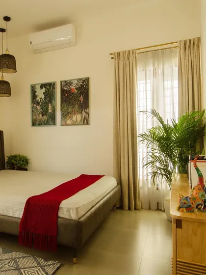 A serene bedroom space where simplicity reigns. The combination of off-white walls, warm wood accents, and plenty of natural light creates a timeless and tranquil atmosphere for rest.