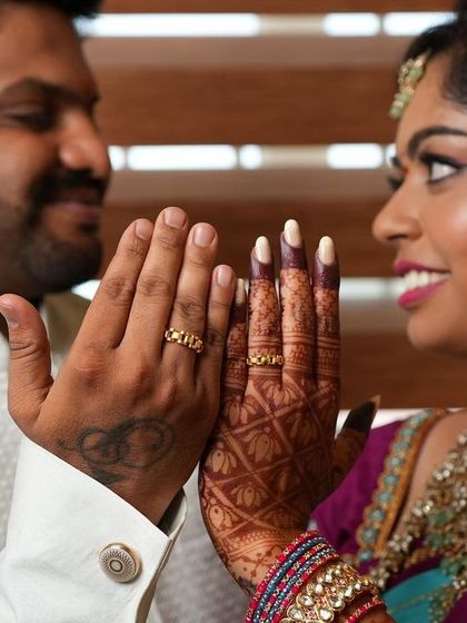 A sweet moment between the couple, showing their rings and the bride's henna-covered hands. It's a testament to how mehendi is part of the celebration of love.