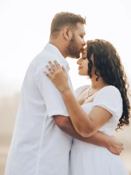 An intimate golden hour portrait of Janice and Lyle. The warm backlighting highlights their connection and creates a soft, romantic glow.
