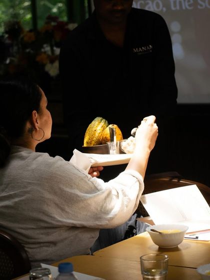 A truly unique part of our chocolate workshop is tasting fresh cacao fruit. Here, a participant examines the pod, getting a rare opportunity to experience the raw ingredient before it's transformed into the chocolate we know and love.