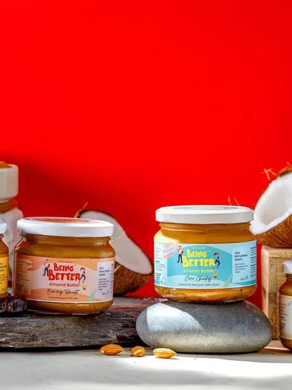A vibrant shot of the Being Better product range against a bold red background. This energetic image is designed to stand out and effectively showcases the different flavors available.