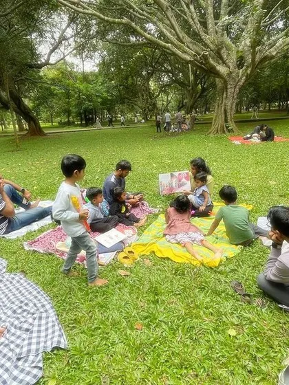 A series of photos from our 'Courage' themed session, showing different angles of the group and the beautiful, leafy surroundings of our storytelling spot.