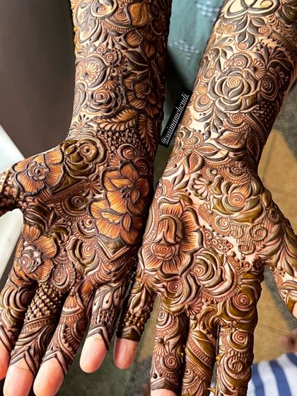 A stunning pair of hands showcasing a full-coverage floral design. The shading and line work create a beautiful sense of depth.