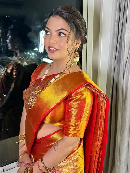 The bride looks away from the camera, showing off her profile and the glowing finish of her makeup.