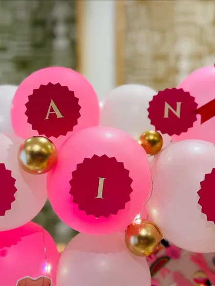 Personalized balloons spelling out 'ARIANA', adding a bespoke and celebratory touch to her birthday hamper.
