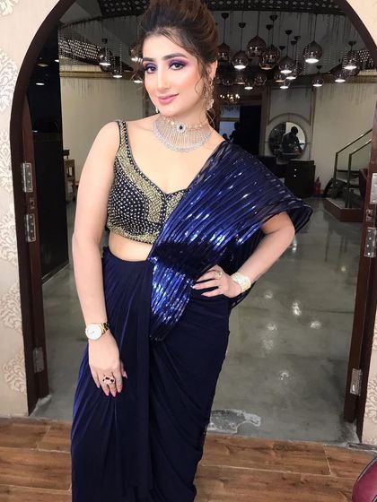 The full look, showcasing a modern saree with a heavily embellished blouse. The makeup is designed to be a statement.