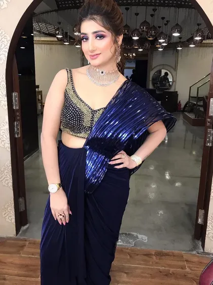 The full look, showcasing a modern saree with a heavily embellished blouse. The makeup is designed to be a statement.