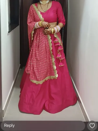 The complete look of the custom pink lehenga, showing the fit of the blouse and the flow of the skirt. The tassel details on the dupatta add a traditional touch.
