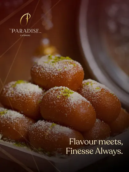 Flavor meets finesse, always. A close-up of our soft, syrupy Gulab Jamuns, dusted with coconut and pistachios, a timeless Indian dessert.