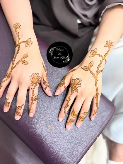 The completed floral vine design, showing how it looks on both hands. The pattern is light and airy, with plenty of open space.