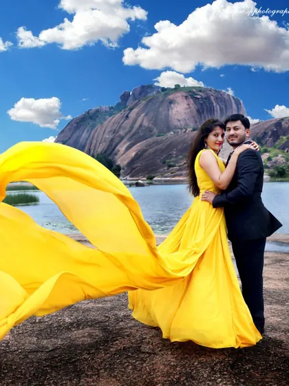 Our pre-wedding shoots are about telling your unique story. Here, we created a dramatic, cinematic scene with a flowing gown against a stunning landscape, showing how we can turn your photo session into a piece of art.