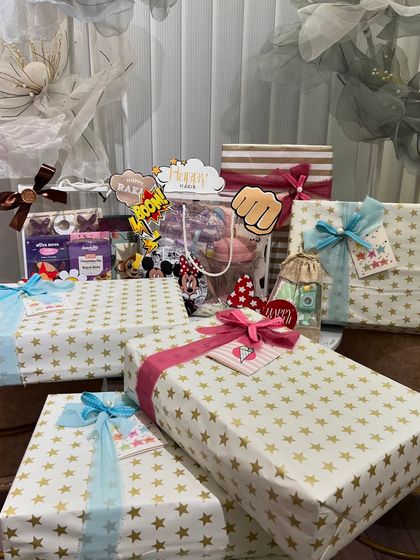 A collection of some of my favorite Rakhi curations. This includes a fun, comic-themed hamper and beautifully wrapped gifts with star-patterned paper.