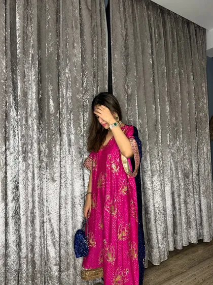 A candid moment during Diwali. The vibrant pink of this kaftan suit feels so joyful and perfect for the festival of lights.