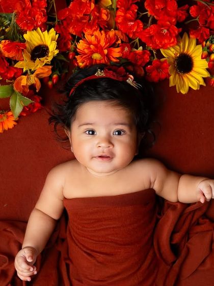 This older baby is beautifully framed by an arch of autumn-colored flowers. I also offer milestone sessions for babies beyond the newborn stage.