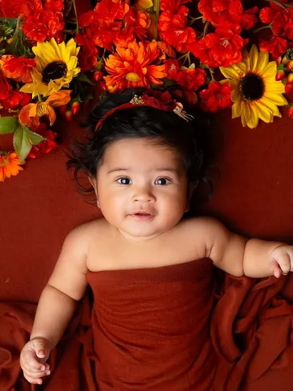 This older baby is beautifully framed by an arch of autumn-colored flowers. I also offer milestone sessions for babies beyond the newborn stage.