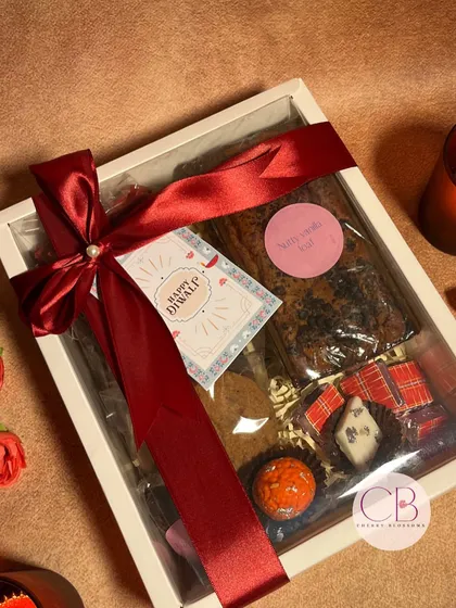 Celebrating the festival of lights with a touch of sweetness. Our confectionery hamper is packed in a beautiful white box and includes a dry cake, cookies, and a variety of handmade chocolates.