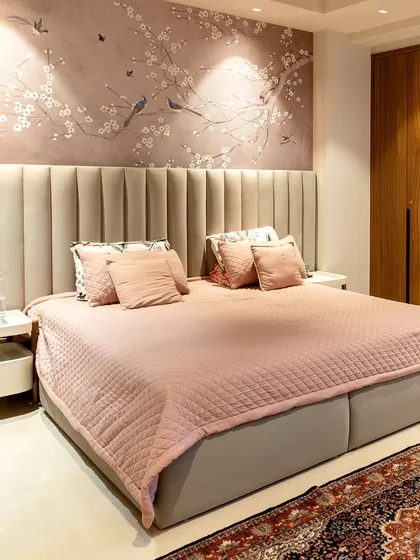 We designed this master bedroom to be a true sanctuary. The blush-toned bedding and vertically channeled headboard create a soft, inviting feel, while the bespoke cherry blossom wall mural adds a touch of serene, artistic elegance. It’s a space crafted not just for rest, but for complete restoration.