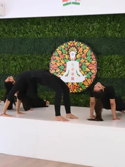 Our team of instructors demonstrates their strength and flexibility with a synchronized backbend sequence. This showcases the skill and dedication that our teachers bring to every class.