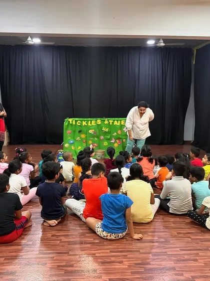 A full view of a puppet show at a summer camp. The kids are all sitting patiently, excited for the story to begin.