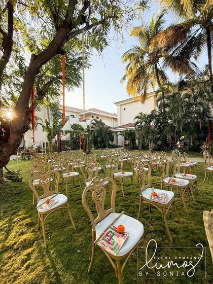 A sunny shot of the outdoor wedding seating, with traditional hand fans on each chair, ready to welcome guests.
