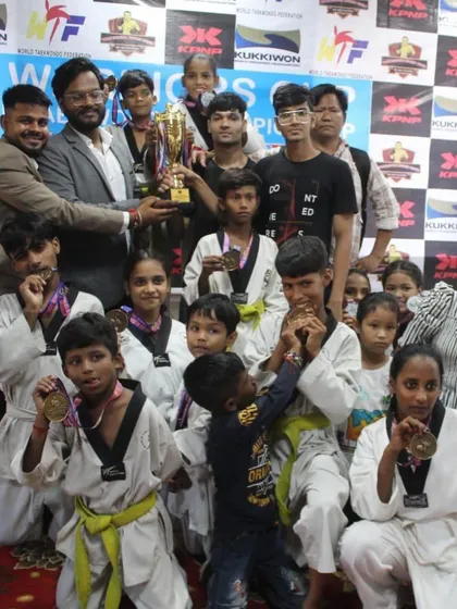 A proud moment for my team from the Warrior Fight Club after a successful championship. You can see the joy and sense of accomplishment as the students hold up their trophy and show off their hard-earned medals. This is the result of their dedication and hard work.