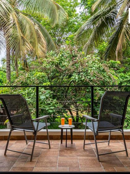 A quiet corner on a private balcony, offering two chairs and a small table. It's these thoughtful details that elevate a guest's stay from good to great.