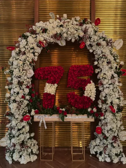 For a 73rd birthday, I designed this grand floral arch with numbers made of red and white roses. It served as a personalized and celebratory focal point for the milestone event.