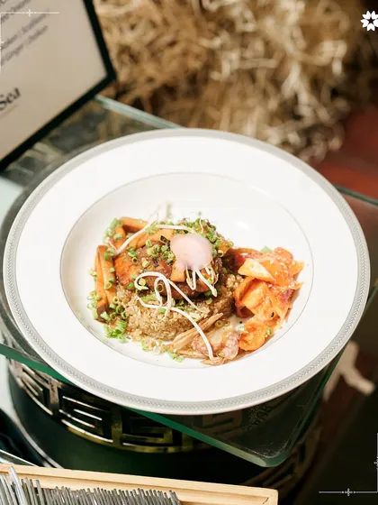 A modern Asian inspired dish featuring quinoa, kimchi, and perfectly cooked fish. The plating is clean and architectural, reflecting a balance of flavours and textures.