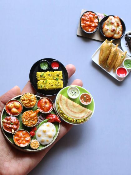 A handful of my favorite miniatures, including a non-veg thali, dosa, and dhokla.