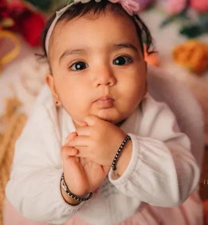 A close-up of this little darling. Her thoughtful expression and clasped hands are just too precious.