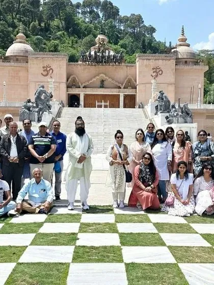 The full group gathered in front of a beautiful temple-like structure in Himachal. These excursions to spiritually significant sites are an integral part of our retreats.
