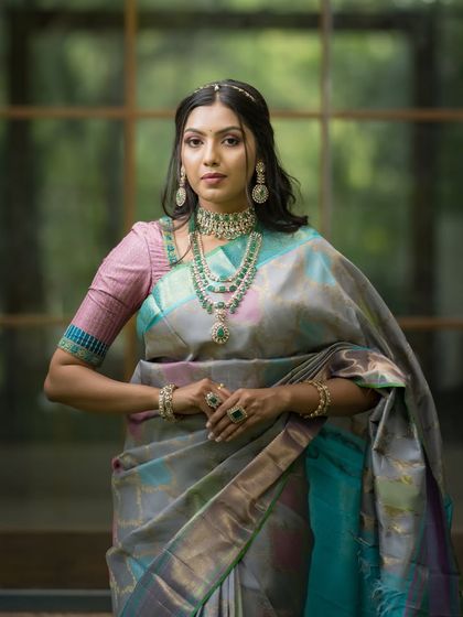 A portrait of our model in the multi-tonal Kancheevaram silk, her confident gaze matching the bold yet elegant saree.