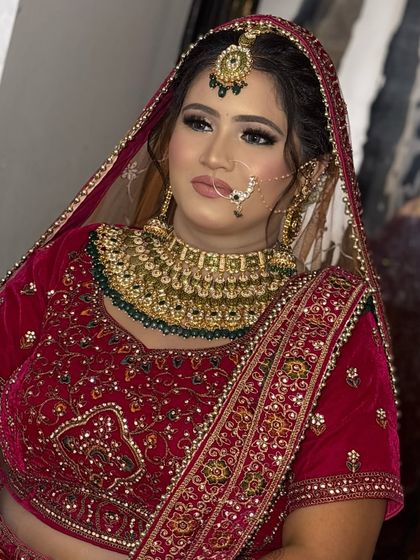 A three-quarter profile of the bride, showcasing the contouring and highlighting that defines her features beautifully.
