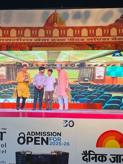Another shot of our team receiving the award on stage, a testament to our hard work and dedication to community events.