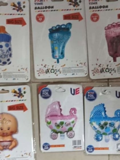 I have a wide variety of themed foil balloons. This collection shows some popular options for baby showers, including 'It's a Boy' milk bottles, baby feet, and strollers in both pink and blue.