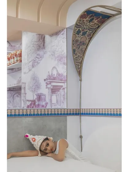 This frame captures the three layers of Indian contemporary art by Trupty Somaiah: the main wall mural, the partition wall, and the fabric-inlaid arches.