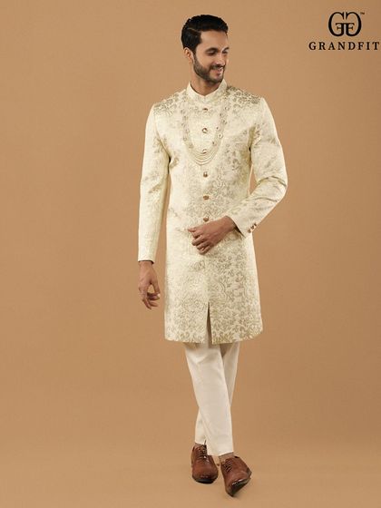 The fluid movement and impeccable structure of our bespoke wedding sherwani. Each piece is tailored to allow for natural movement while maintaining its regal form throughout the celebration.
