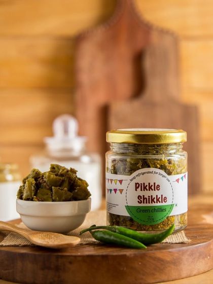 A jar of my homemade Green Chilli pickle, made with fresh chillies and traditional spices. It's a simple but powerful addition to any meal.