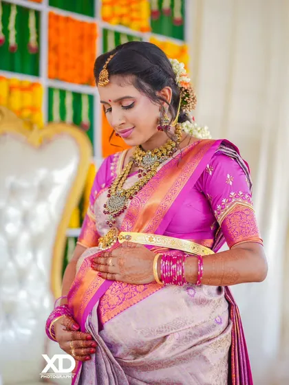 A close-up portrait capturing the mother-to-be's gentle expression as she cradles her baby bump during the ceremony.
