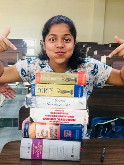 A fun throwback to my law school days. This picture perfectly captures my life back then: surrounded by heavy law books like the Civil Procedure Code and Torts, but always with a smile.