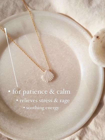 A detailed look at the 'saṅkha' Howlite Shell Pendant, showing the delicate carving. This piece is all about bringing soothing energy, patience, and calm.