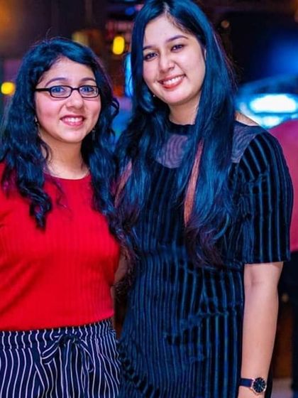 Two friends smiling for the camera. My goal is to create a welcoming and fun atmosphere for everyone.