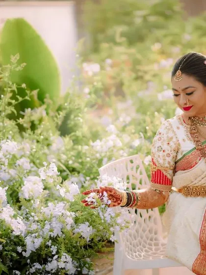 A serene moment before the ceremony. This image showcases the intricate details of the bride's custom blouse, designed to match her traditional South Indian wedding saree.